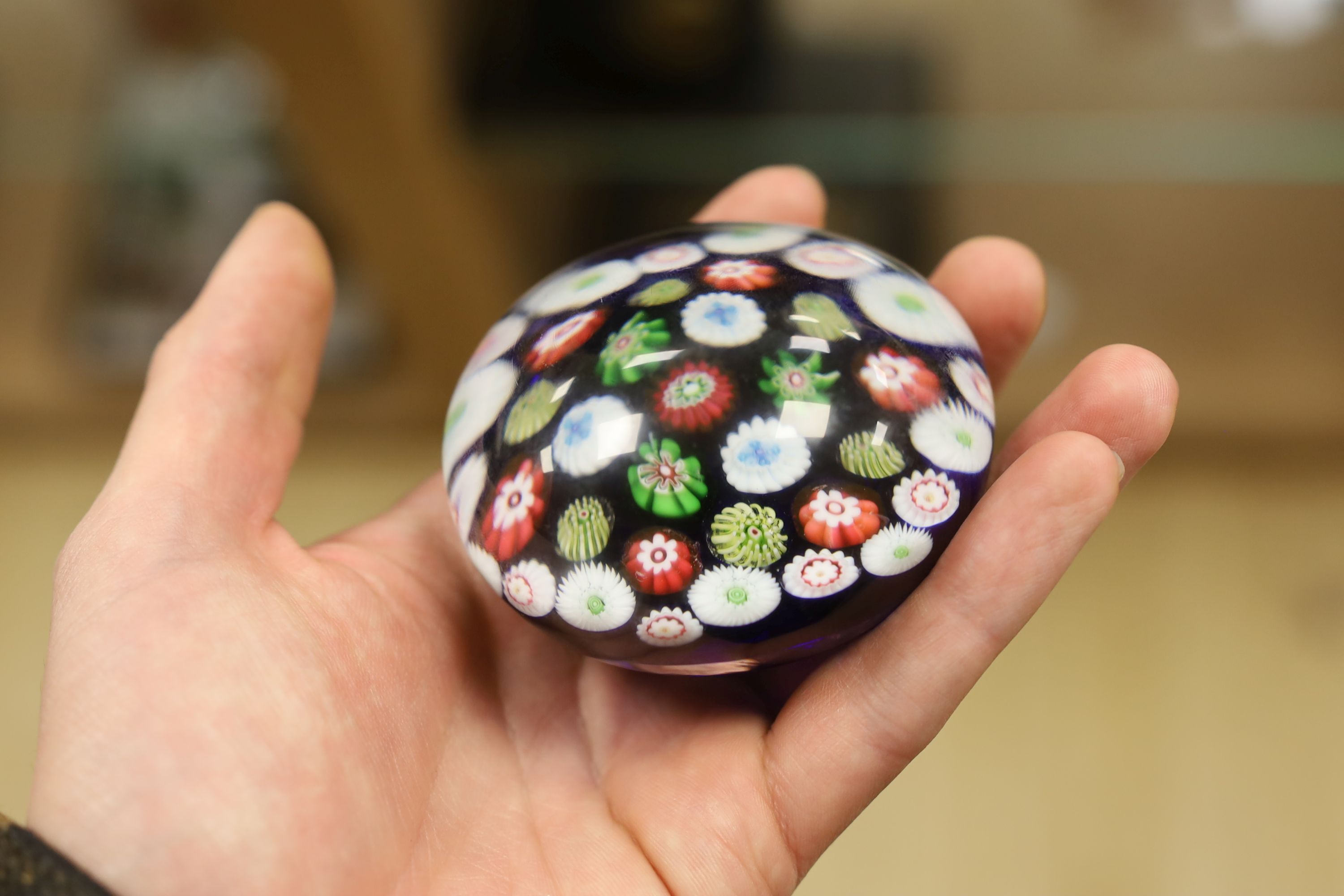 A Clichy translucent blue ground millefiori glass paperweight, 7cm in diameter